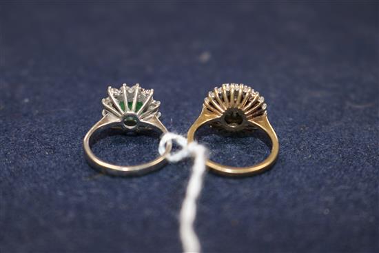 An 18ct white gold, emerald and diamond cluster ring and a 9ct gold and diamond cluster ring.